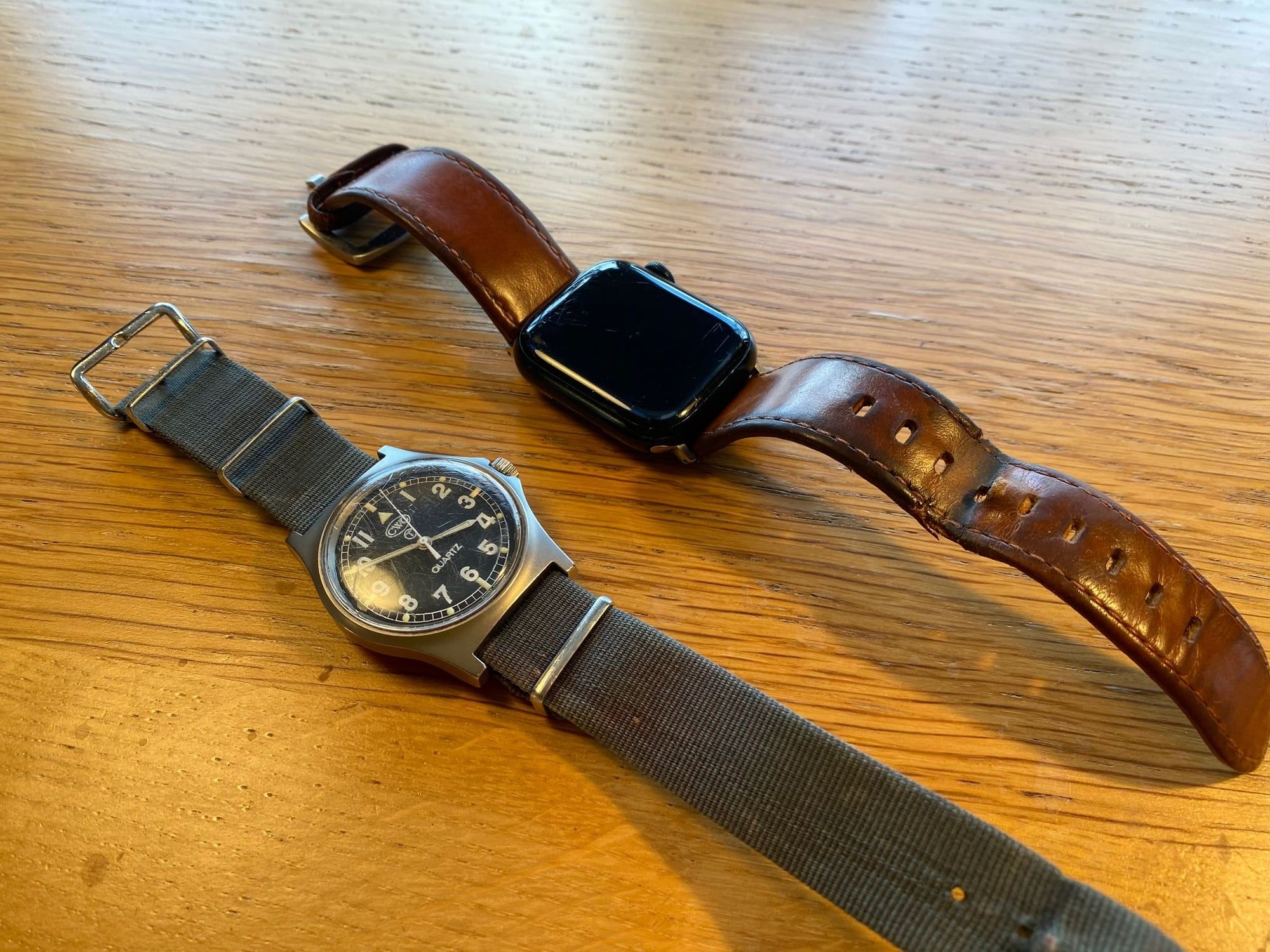 An Apple Watch and a G10 military watch side by side