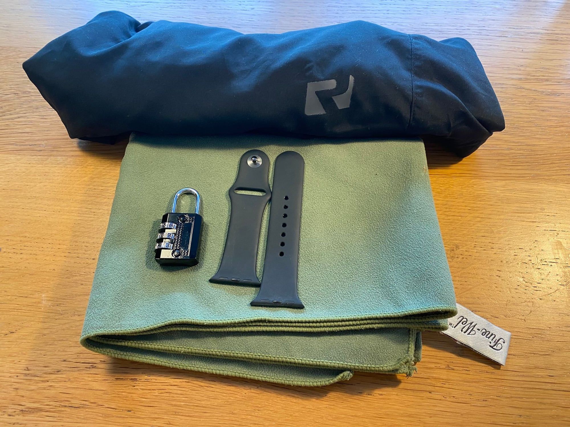 Swimming shorts, a microfibre towel, a padlock and a waterproof watch strap