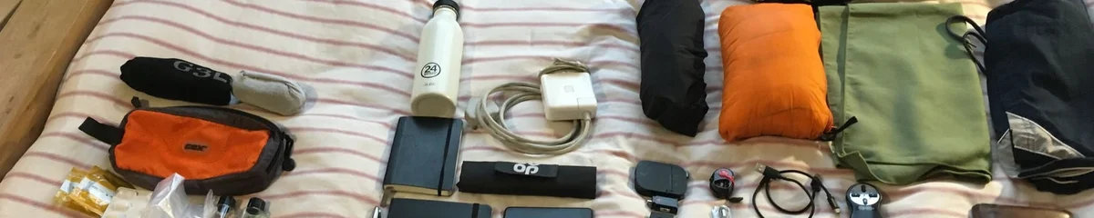 A top-down flat-lay of everything Danny carries in his bag