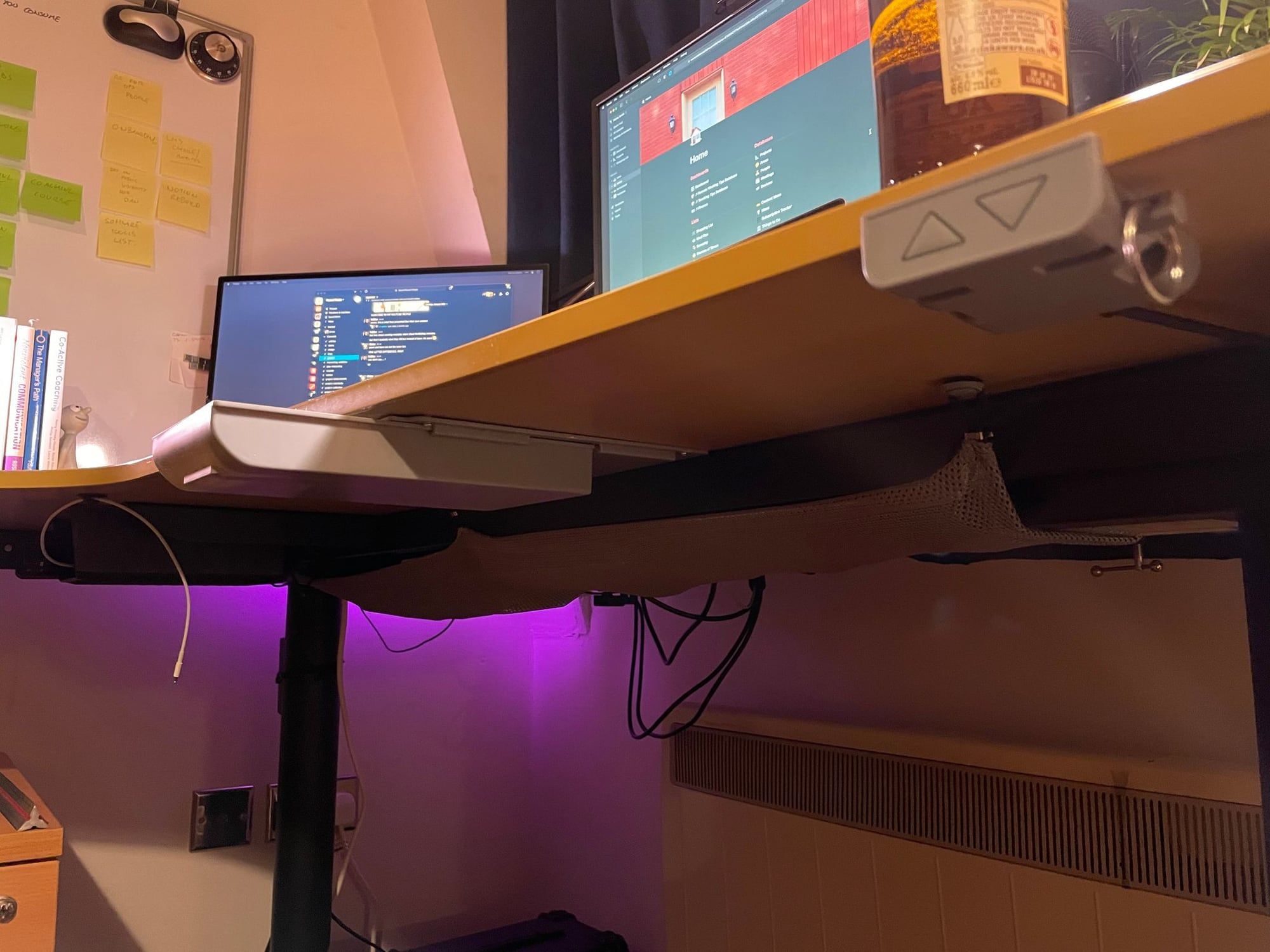 A shallow sliding drawer mounted under the desk