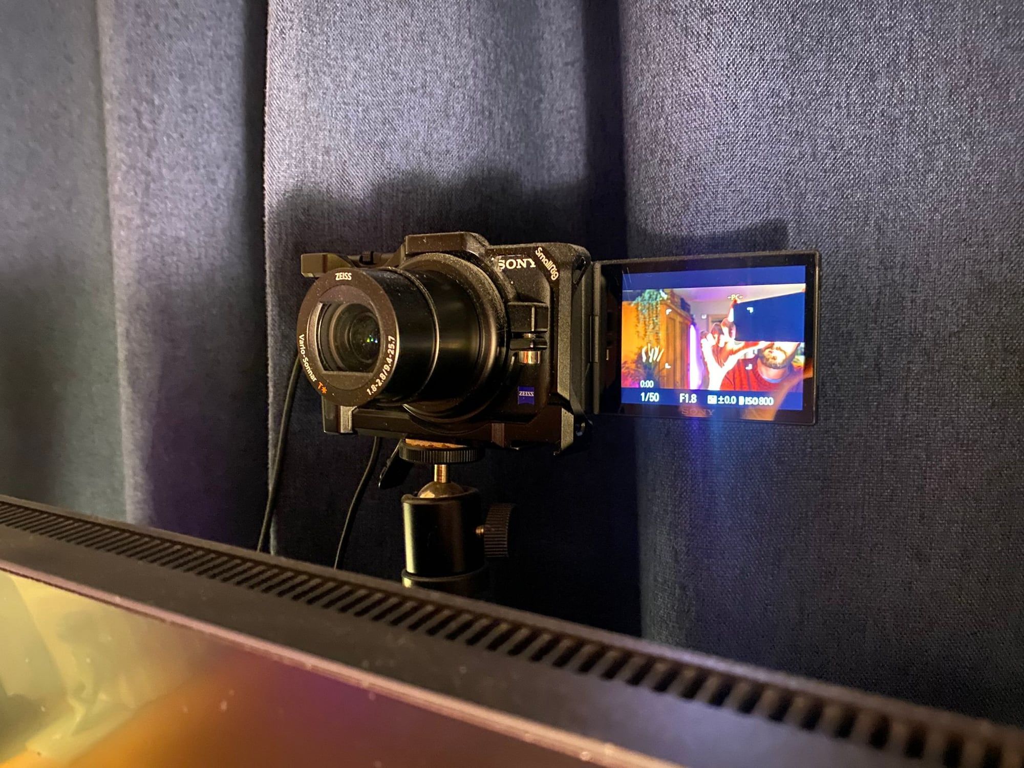 Sony ZV-1 camera on a ball mount above the monitor