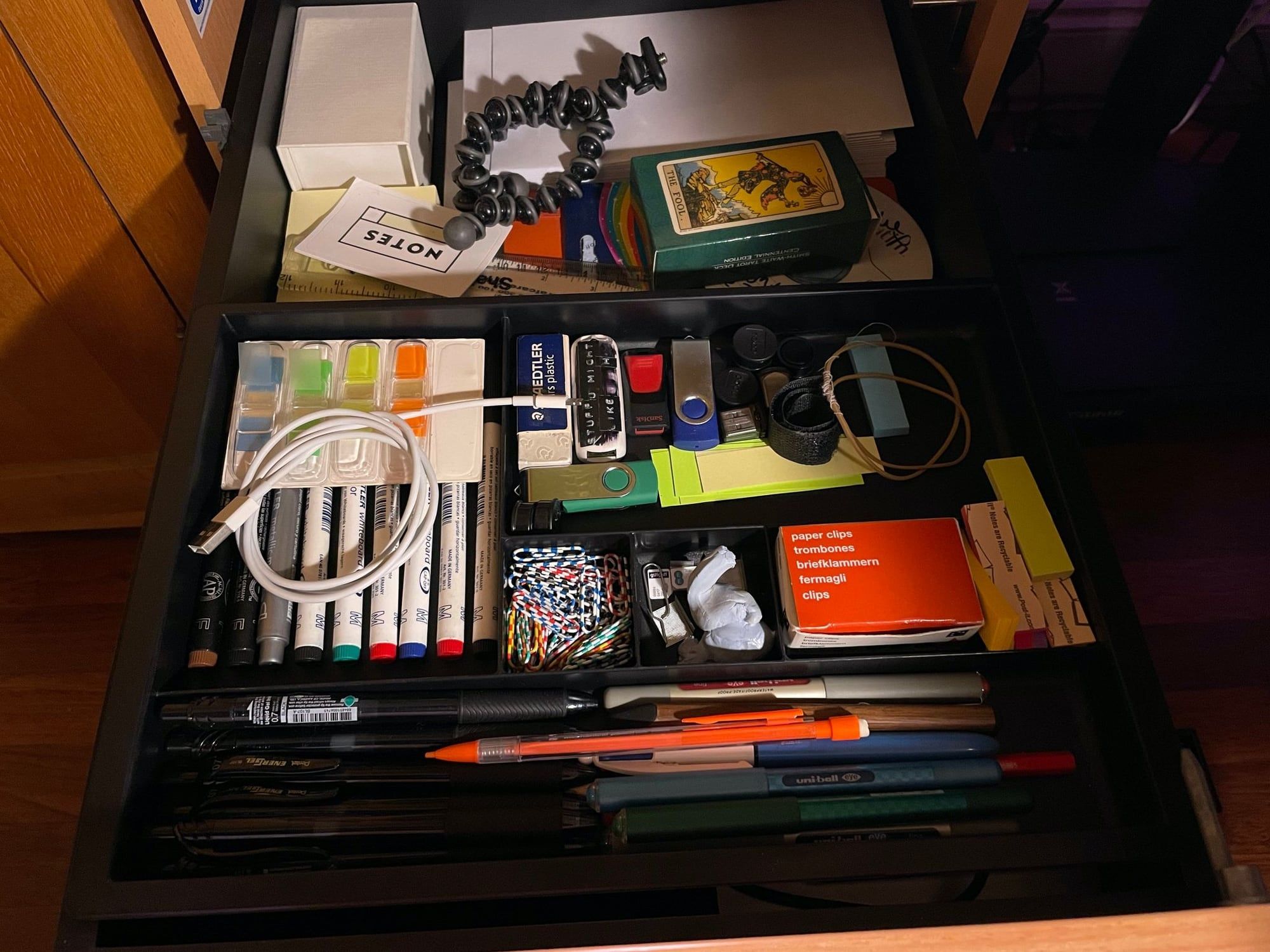 An open drawer of office supplies